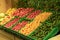 Supermarket vegetables background. Fresh tomatoes and peppers in boxes on the supermarket counter. Food, grocery