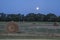 Supermoon over hay bales