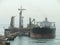 A supertanker VLCC combined, loads of oil in the offshore oil platform
