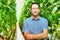 Supervisor standing with arms crossed at greenhouse