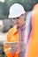 Supervisor writing on clipboard at construction site