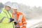 Supervisors using laptop at construction site