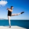 Supple young dancer does the splits on a big stone block.