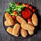 Suppli al telefono on a black plate, top view