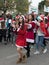 Support group members dressed as Santa Claus entertain participants and visitors of the annual race `Cristmas Run` in Mi`ilya in I