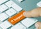 IT Support - Inscription on Orange Keyboard Key