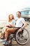 Supportive mature couple in wheelchairs smiling cheerfully