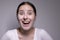 Suprised brunette woman, isolated on gray background. happy actress portrait. human emotions, facial expression concept