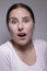 Suprised brunette woman, isolated on gray background. happy actress portrait. human emotions, facial expression concept