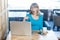 Suprised young girl with blonde hair in blue t-shirt are sitting alone in cafe and having new proposal for a work on laptop,