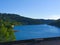 Sure river in Lultzhausen, Esch-sur-Sure, Luxembourg. Beautiful landscape with green mountains and a bench in the foreground