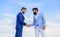 Sure sign you should trust business partner. Men formal suits shaking hands blue sky background. Entrepreneurs shaking