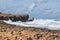 Surf around a cliff on a sunny day in Cuba.