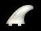Surf Board fins, being held by a hand on a black background.