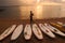 Surf boards line the beach decorating the rising sun on the coast of Sanur