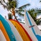 Surf boards lined up beach palm tree hawaii