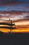 Surf boards silhouetted against vibrant yellow orange sky with clouds at sunset