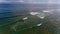 Surf coast on green bowl beach. Aerial view.