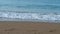 The surf of the gentle sea wave on the Turkish coast. Sandy beach.