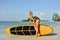 surf girl posing on a beach in summertime