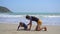 Surf instructor teaches little boy how to surf