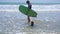 Surf instructor teaches little boy how to surf