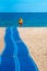 A surf lifesaver walks along a blue sand mat