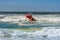 Surf rescue life savers boat jumping on the waves at Wanda Beach, NSW, Australia