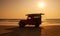 Surf rescue vehicle on beach at sunset