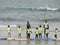 Surf school with children and teachers on the beach