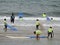 Surf school with children and teachers on the beach