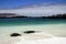 Surf wash round black boulders with white sand in natural turquoise pool - Bahia Inglesa at pacific coast of Atacama desert, La