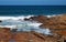 SURF WASHING OVER ROCKS IN THE SEA