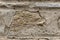 Surface of beige sandy rock. Durable building material and archaeological site. Background. Space for text
