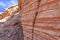 Surface of a crumbling hill with multi-colored layers of rock. Red Canyon Israel