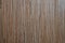 Surface of dark brown grange timber texture with vertical dark brown and grey stripes. Wooden pattern