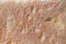 The surface of fresh homemade bread, pastries as a background, close-up, large grain