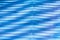 Surface, geometric pattern of the ends of thick glass. Blue glass background, diagonal lines and strips