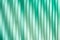 Surface, geometric pattern of the ends of thick glass. Green glass background, lines and strips