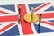 On the surface with the image of the flag of Great Britain are bitcoins and miniature figurines of people