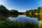 Surface of a lake with reflection of forest and Andes mountains in Patagonia.