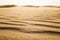 Surface level shot of the desert and the wind pattern on the sand