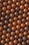 The surface of the many balls for shooting from an air gun. View from above. Background or wallpaper. Vertical shot. Macro