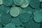 Surface of many Russian coins of 10 ten rubles. Dark green tinted background. Money wallpaper. Backdrop on an economic, financial