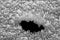 Surface of a metal with a hole observed with an electron microscope