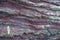Surface of natural uneven volcanic Purple slate stone. Japanese Zen Stones Garden.