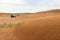 Surface of sand or soil wave lines after rain. Car on blur background