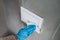 Surface sanitizing wipes of home surfaces, wall button switches wiping paper towel sanitizer with gloves