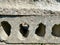 Surface texture of solid gray construction concrete cement slab with holes. The background