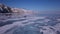 Surface of transparent fissured black ice of The Baikal Lake in winter